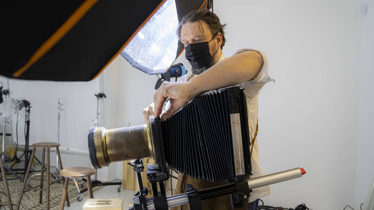 Valokuvaaja Marko Rantanen valmistelee kameraansa kuvauskuntoon.