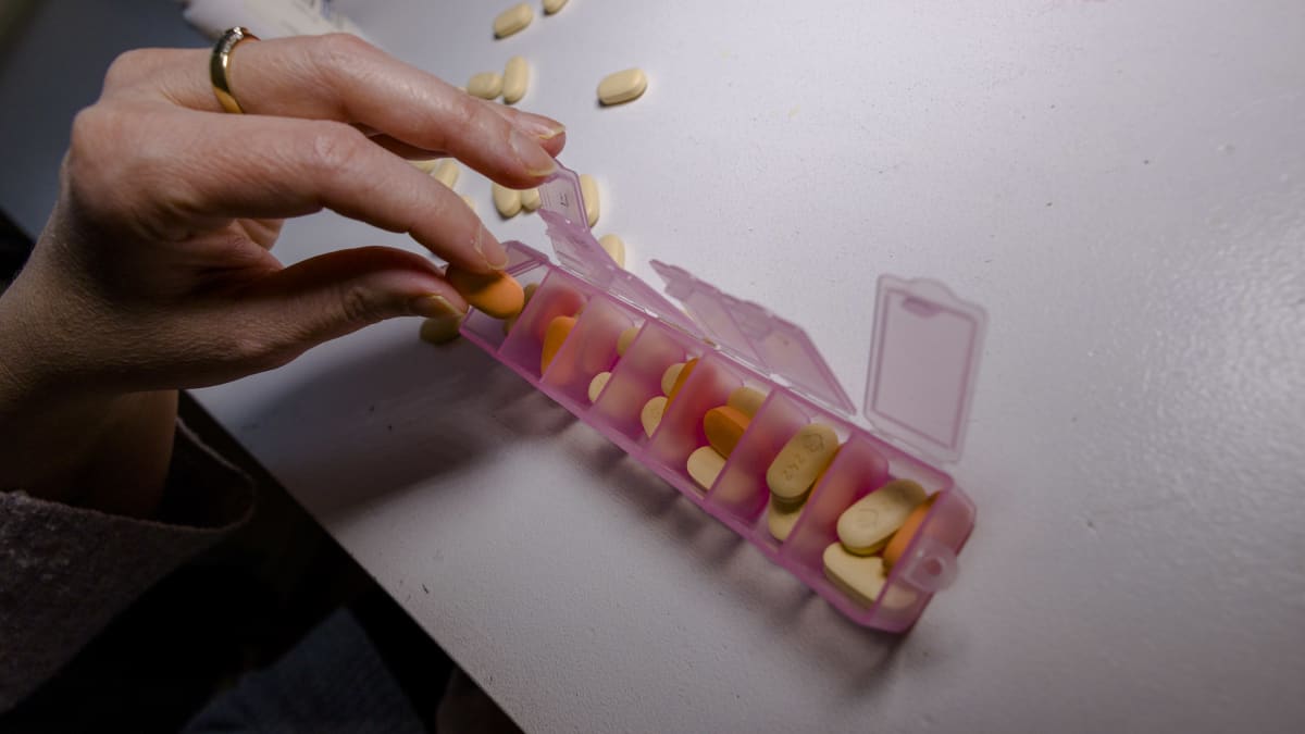 Photo shows HIV medication in a plastic container.