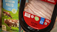 A milk carton and cold cuts package with logos indicating their climate impact. 
