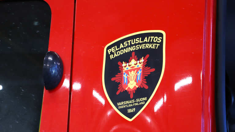 Punaisen paloauton ovessa on logo, jossa lukee Pelastuslaitos, Varsinais-Suomi.