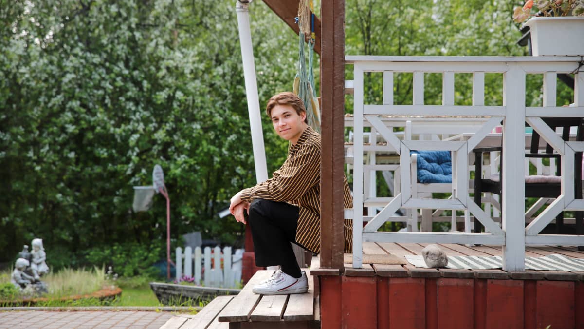 Rovaniemeläinen Olavi Angervo istuu kotinsa portailla. 