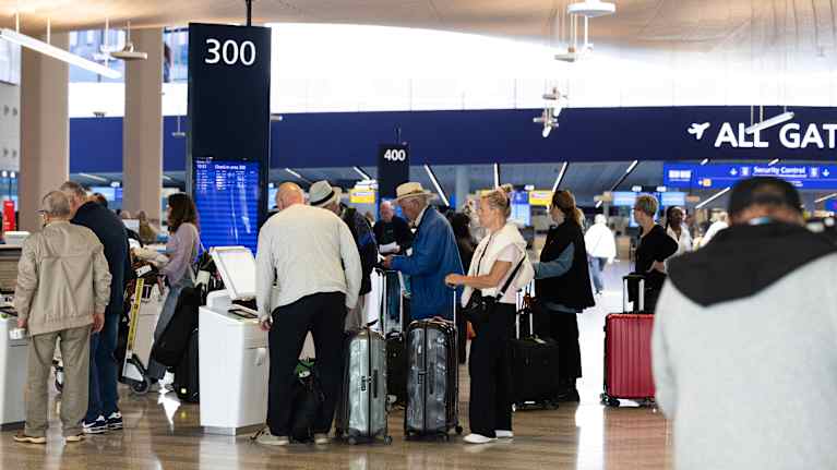 Travellers lining up at Helsinki Airport. 