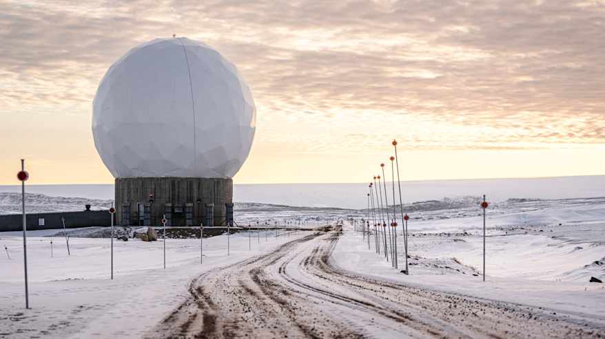 Kuvassa näkyy lumipeitteisessä maisemassa sijaitseva suuri valkoinen, pyöreä rakennelma.