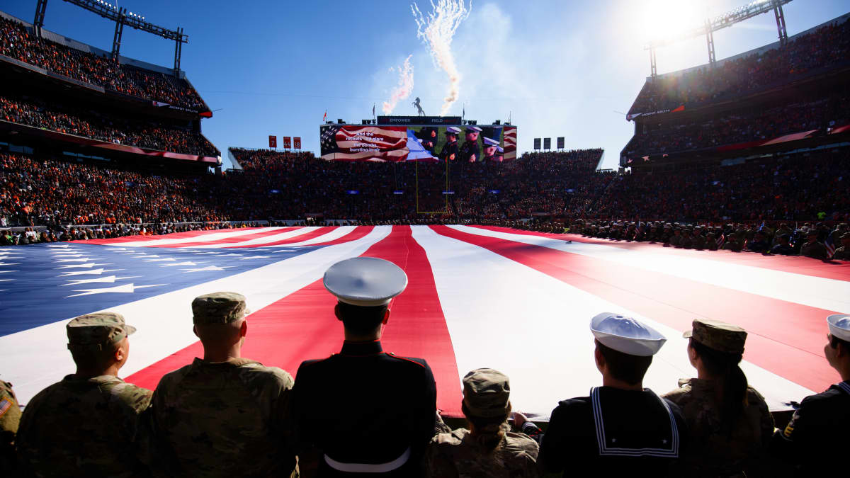Sotilaita pitämässä jättimäistä Yhdysvaltain lippua NFL-ottelussa kansallislaulun aikana.