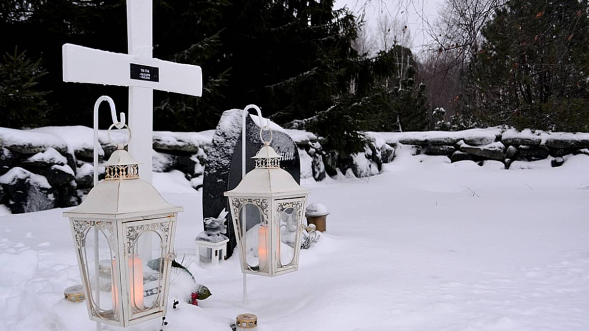 Alatornion  hautausmaan luminen uurnalehto. Etualalla kaksi valkoista lyhtyä, joissa palaa hautakynttilä. 