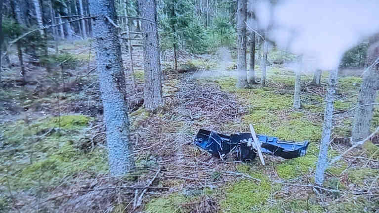 An image of a badly damaged drone on a TV screen.