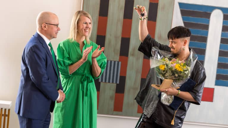 Käärijällä käsissään uuden asunnon avaimet, jotka hän on saanut Vantaan kaupungin edustajilta.