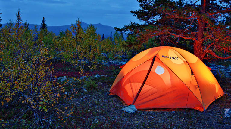 A tent overnight in the Korvatunturi landscape, with the fells in the background. 