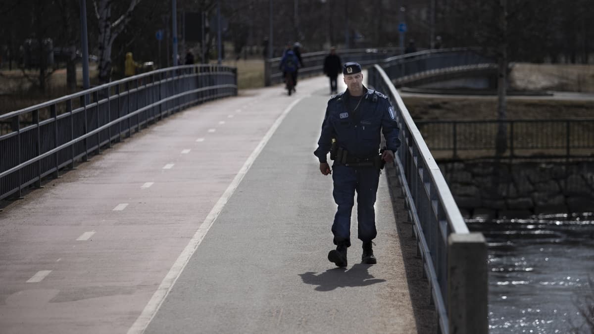 Poliisimies kävelee sillalla