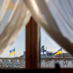 Photo shows Finnish and Ukrainian flags flying side by side.