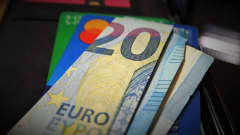 20 euron seteli luotto- ja pankkikortin päällä.