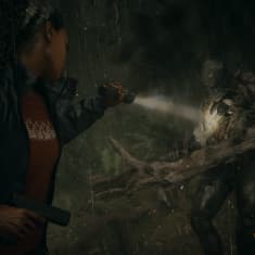 Kiharahiuksinen nainen osoittaa taskulampulla hirviötä, joka pitää käsissään puuntukkia. Naisella on toisessa kädessään pistooli ja hänen takissaan lukee FBI.