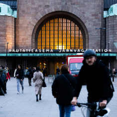 People in street in front of Helsinki's Central Railway Station. 