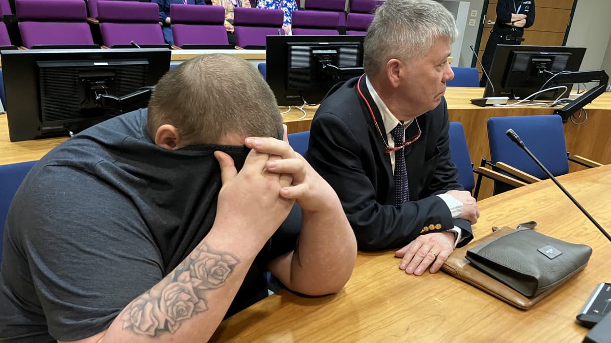 The defendant covered his face in court.