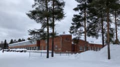 Iso koulurakennus talvisessa maisemassa Simon kunnassa.