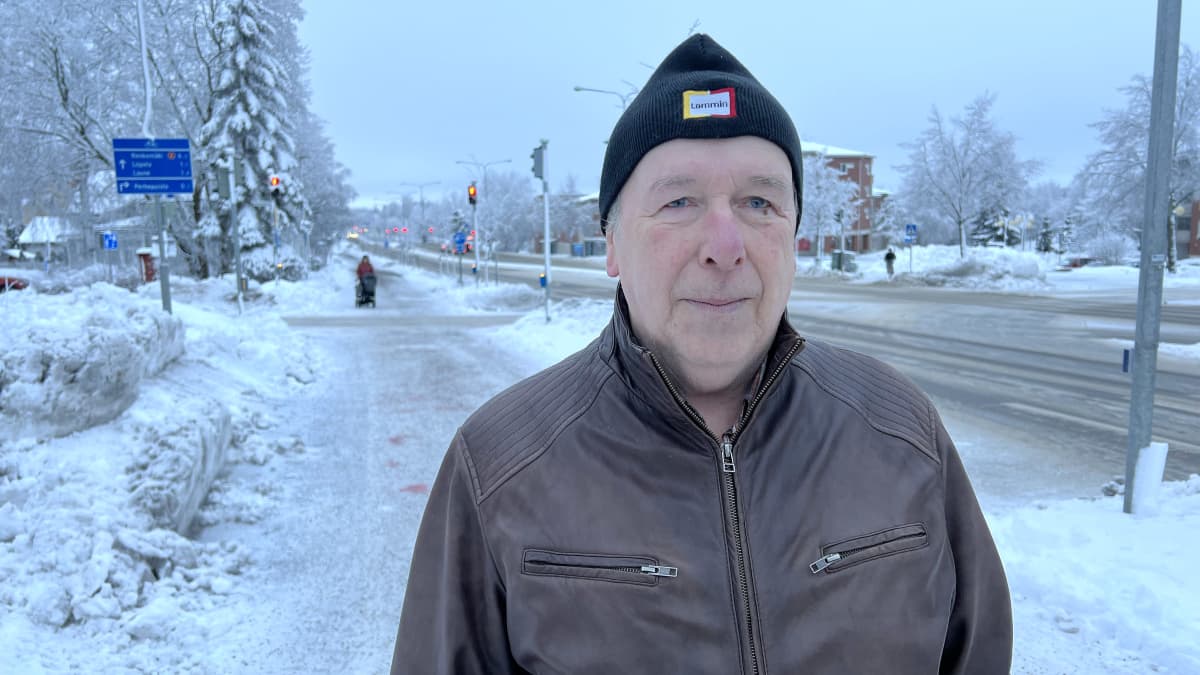 Vesa, joka ei kerro sukunimeään, katsoo kameraan Lahden Uudenmaankadulla. Pipo päässä ja ruskea nahkatakki yllään, talvinen sää.