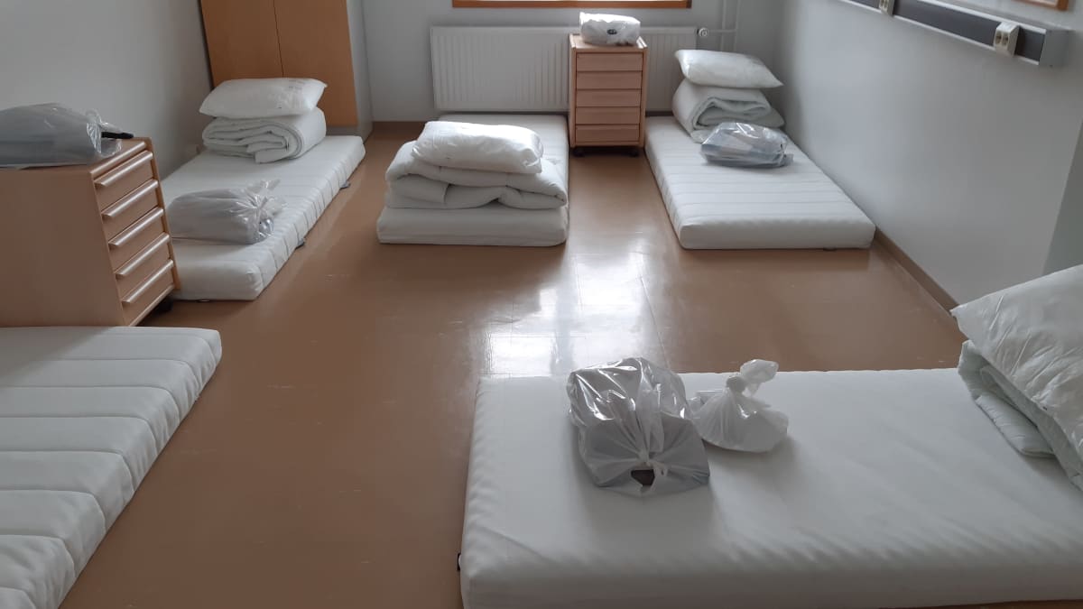 Mattresses, pillows and blankets on the floor of a reception centre in Finland.