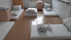 Mattresses, pillows and blankets on the floor of a reception centre in Finland.