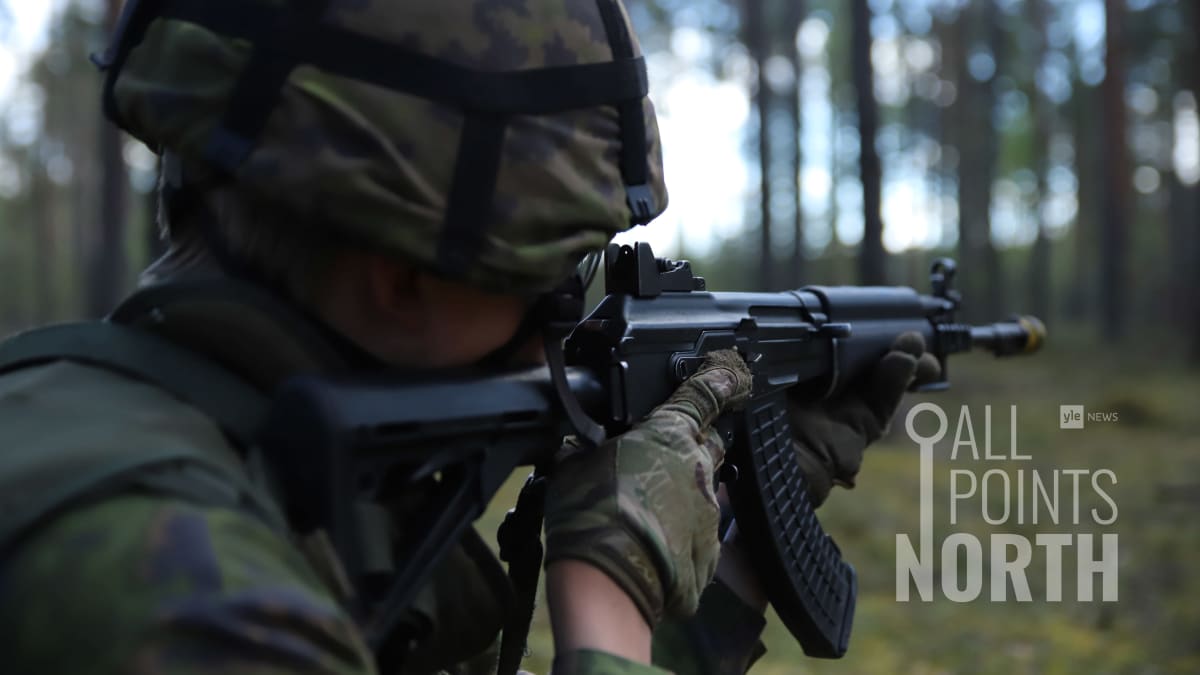 Photo of a Finnish soldier taking aim during an exercise, featuring the All Points North podcast logo.