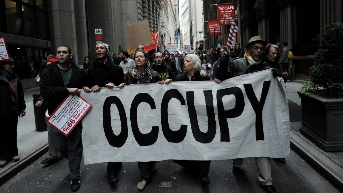 Occupy Wall Street -mielenosoittajat marssivat New Yorkin pörssin lähistöllä 17. marraskuuta 2011.