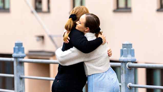 Photo shows two people hugging.