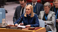 Woman with blonde hair sitting at a desk and speaking at a UN Security Council meeting with a microphone in front of her.