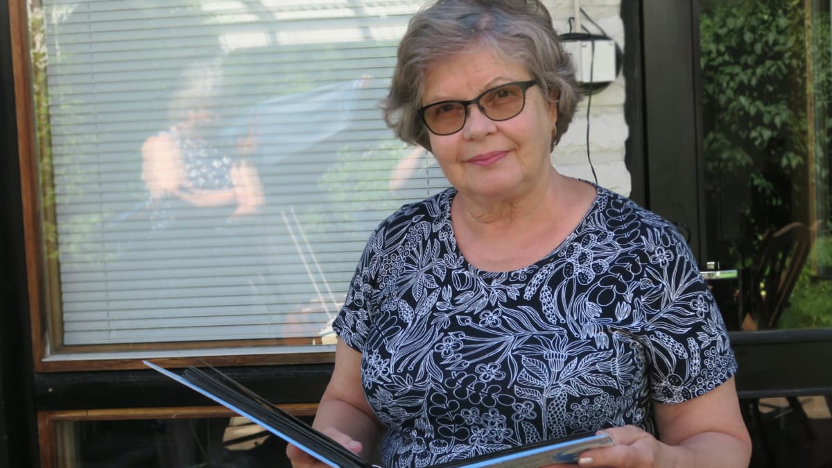 Tuija Seppänen katsoo valokuvia