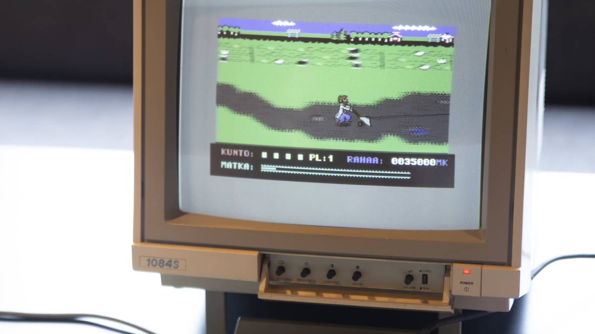 Commodore 64 tietokone ja näyttö jossa Uuno-peli.