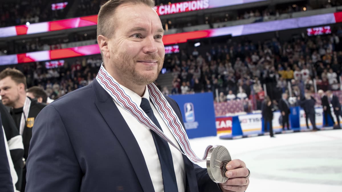 Pekka Kangasalusta hymyilee MM-hopea kaulassa.