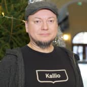 Janne Palander, kirjastovirkailja seisoo joulukuusen vieressä Kallion kirjastossa.