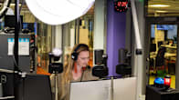 Photo shows Yle journalist Anna Sirén presenting a radio programme from the broadcaster's studio in Tampere.