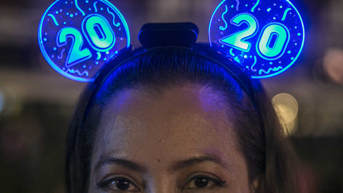 Nainen päässään siniset 2020-valot.