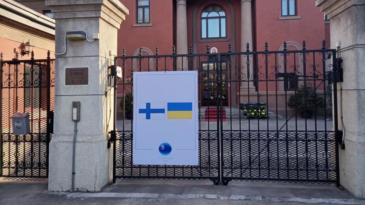Suomen suurlähetystö Pekingissä. Porttiin on kiinnitetty kyltti, jossa on kuva Suomen ja Ukrainan lipuista rinnakkain.