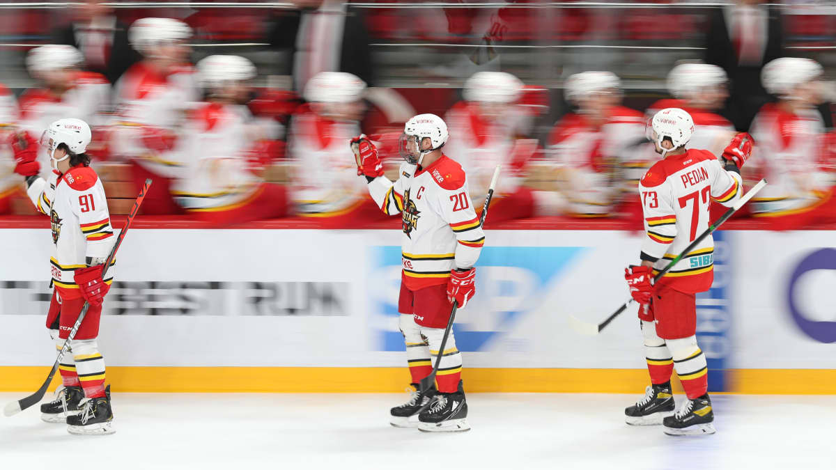 KHL-seura Kunlun Red Starin pelaajat juhlivat maalia vaihtoaition edessä