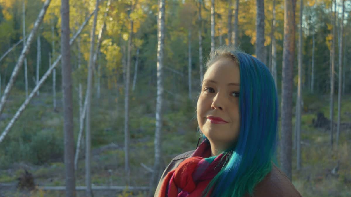 Musiikintutkija Anna-Elena Pääkkölä ulkona metsätaustaa vasten.