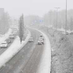 Snöyra på avfart till en motorväg. På bilden syns flera personbilar som kör på en snöig väg.