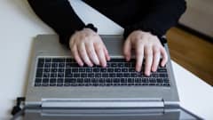 Hands on laptop keyboard