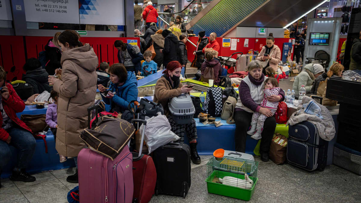 Ukrainalaispakolaiset tungeksivat Puolan Krakovan rautatieaseman tukipisteessä 14.3.2022.