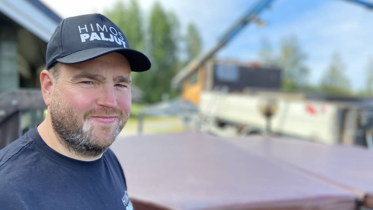 Himospaljut yrityksen toimitusjohtaja Kalle Järvelä on kannellisen paljun edessä ja taustalal näkyy kuorma-auton nosturi, jolla hän tuo vuokrapaljun asiakkaalle