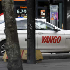 Photo shows a taxi carrying the Yango branding.