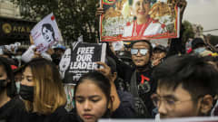 Aung San Suu Kyin kannattajat kantavat hänen kuvaansa mielenosoituksessa Yangonissa juntan vallankaappauksen jälkeen helmikuussa 2021.