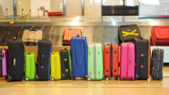A row of luggage in an airport baggage claim area.
