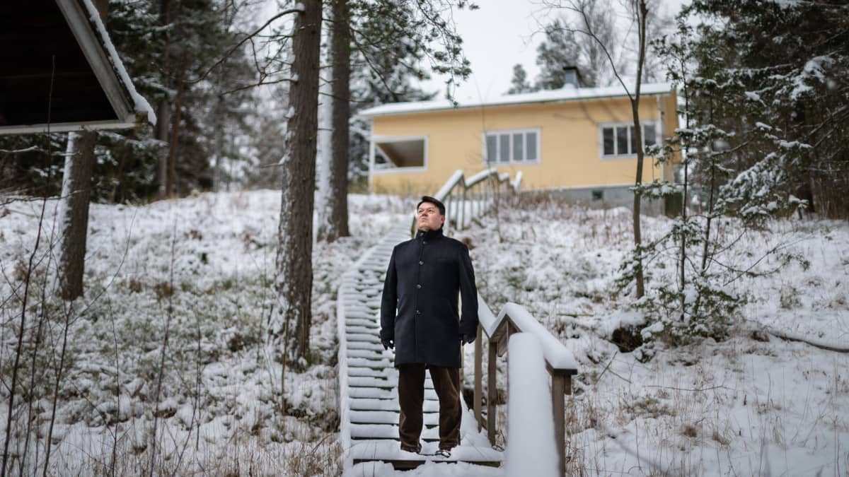 Maailman ilmatieteen järjestön pääsihteeri Petteri Taalas seisoo portailla ja katsoo kauas järvelle mökillään Nuuksiossa