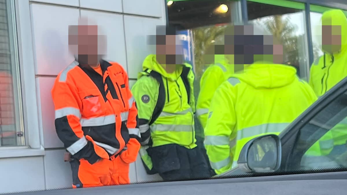 Njerëz me veshje me shikueshmëri të lartë jashtë pikës së karburantit.