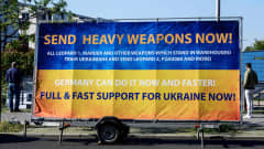 Kadulle pystytetyssä väliaikaisessa mainostaulussa kehotetaan lähettämään raskaita aseita Ukrainaan.