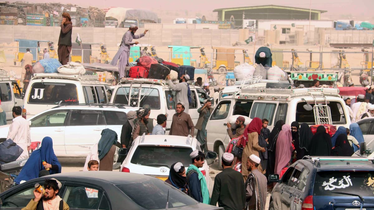 Afgaanipakolaiset odottamassa rajan yli pääsyä takaisin Afganistaniin Pakistanin rajalla.