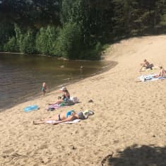 Auringonottajia Kontiolahden Vierevänniemen uimarannalla.