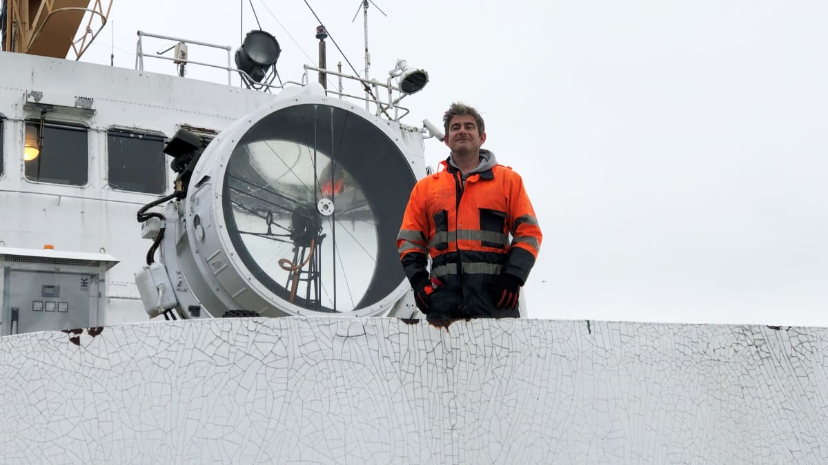 Valotaiteilija Ivo Schoofs seisoo lampun vieressä TUrussa Bore-laivan kannella.
