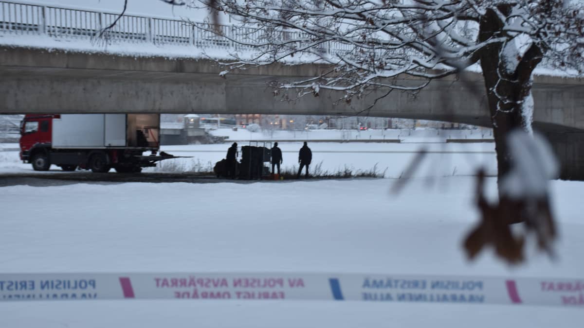 Poliisitutkinta sillan alla. Talvimaisema aamuhämärässä. 