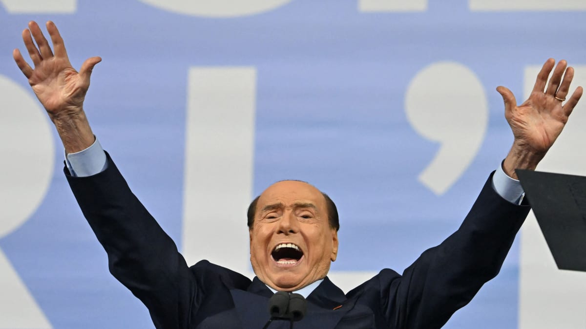 Silvio Berlusconi kädet ilmassa.